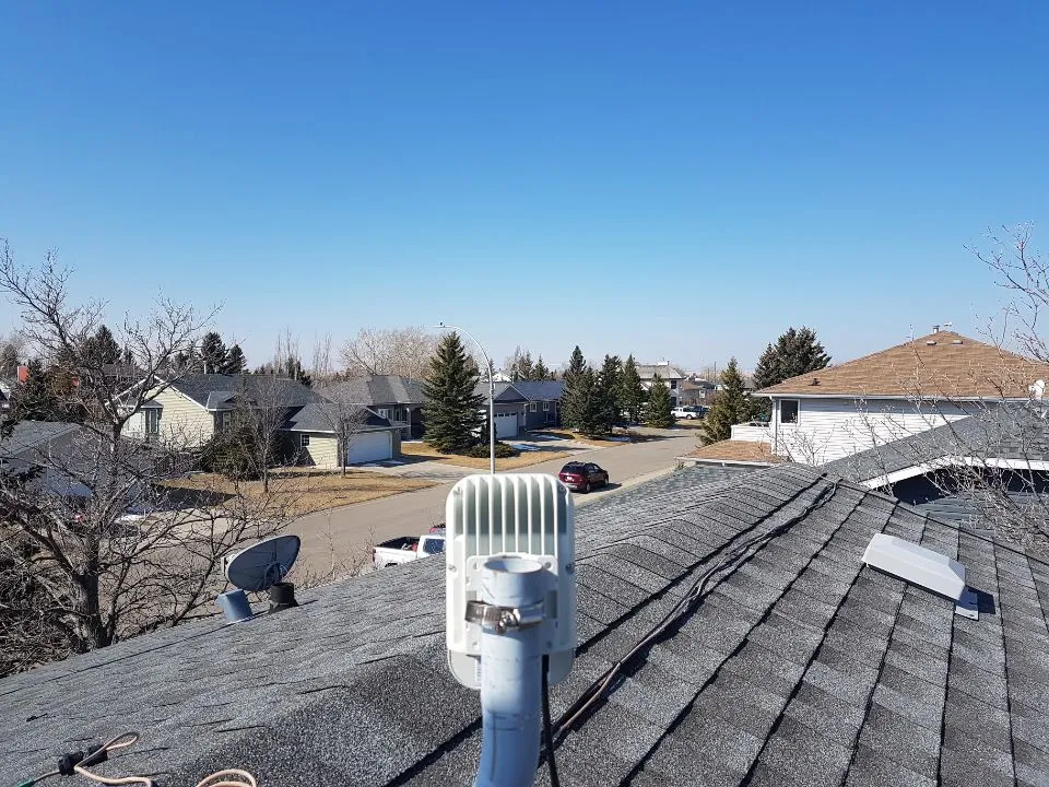 A Cambium V1000 antenna mounted on a house
